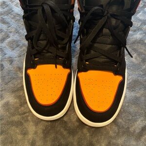 Air Jordan 1 Mid SE Black and Vivid Orange /Cardinal Red.